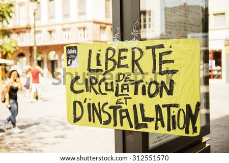 STRASBOURG, FRANCE - AUG 22 2015:People protesting against immigration policy and border management which asks for commitment in the wake of migrants boat disasters - freedom of movement placard