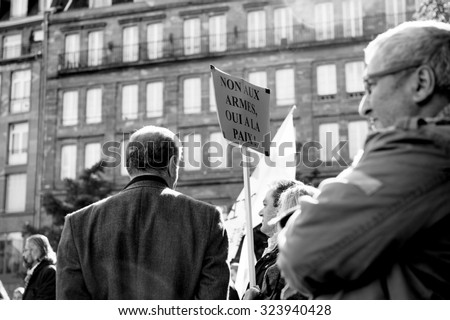 STRASBOURG, FRANCE - OCT 4, 2015 Demonstrators protesting against Turkish President Recep Tayyip Erdogan\'s visit to Strasbourg - To for weapons, yes for peace placard