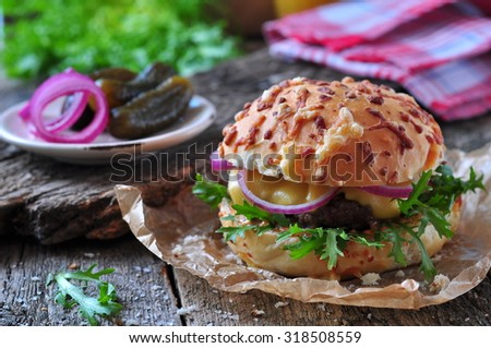 juicy burger with beef, cheese, lettuce, sour cucumber, pickled onions and cheese loaf