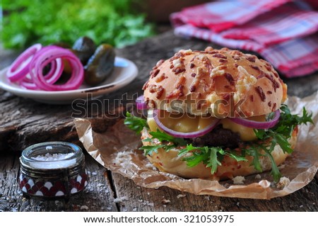 juicy burger with beef, cheese, lettuce, sour cucumber, pickled onions and cheese loaf