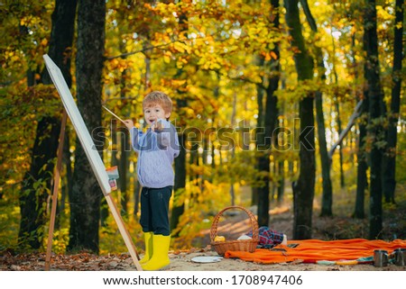 Wall Decor Galore Little Baby Boy Painting With Drawing Easel At Fall Autumn Forest Park Background And Smiling Child Pointing Finger At Camera Funny Happy Kid Children Creativity Concept