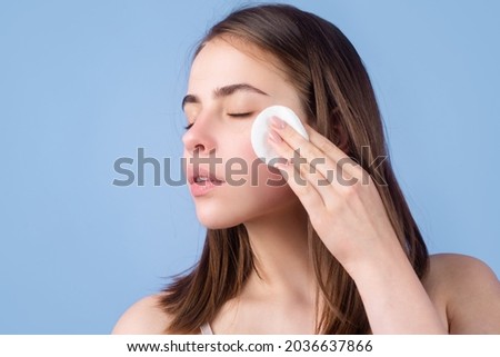 Woman with cotton pads, sponge, cotton ball. Skin care and beauty concept. Girl removes makeup with cotton ball from face. Skin care concept. Woman using cotton pad.