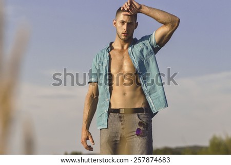 Successful man with a bare chest and attractive face at summer day