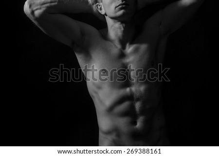 Sexy young naked man with strong abs, horizontal background