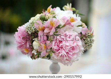 Beautiful bright decorative bouquet of soft peony flowers white pink lilac violet purple colours in white vase on celebration background, horizontal picture