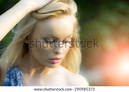 Portrait of pensive sensible blond lady outdoor in summer daylight on natural background closeup, horizontal picture