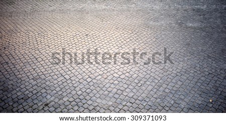 Top view on texture background of straight flat stony brick grey paving stone street road outdoor copyspace, horizontal picture
