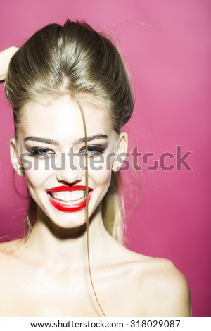 Portrait of happy smiling splendid sexy young blonde girl with bright fashion makeup big smile and bare shoulders looking straight studio closeup on pink background, vertical picture