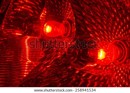 The red tail lights of a car lit up.