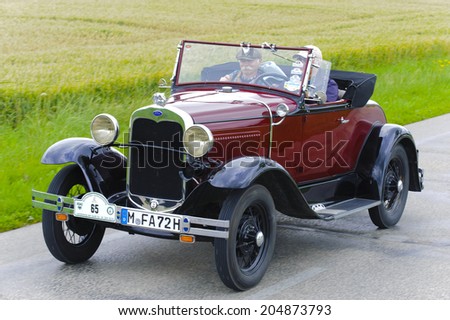LANDSBERG, GERMANY - JULY 12, 2014: Public oldtimer rally organized by Bavarian city Landsberg for at least 80 years old veteran cars with unknown drivers in Ford A Roadster, built at year 1930