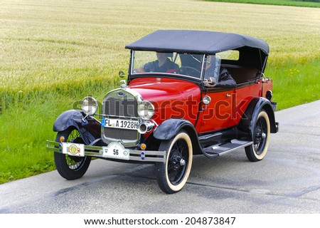 LANDSBERG, GERMANY - JULY 12, 2014: Public oldtimer rally organized by Bavarian city Landsberg for at least 80 years old veteran cars with unknown drivers in Ford A Phaeton de Luxe, built at year 1928
