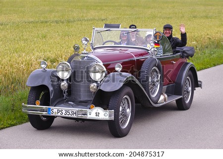LANDSBERG, GERMANY - JULY 12, 2014: Public oldtimer rally organized by Bavarian city Landsberg for at least 80 years old veteran cars with unknown drivers in Mercedes K15/70/100, built at year 1926