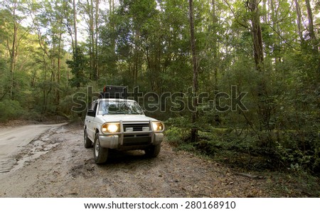 FRASER ISLAND, AUSTRALIA - JUNE 2007 : A white SUV in the tropical forest of Fraser island, the largest sand island of the world off the coast of Queensland Australia.