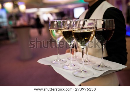 Waiter welcomes guests with sparkling wine