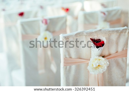 Wedding ceremony chairs. Floral arrangement at a wedding ceremony.