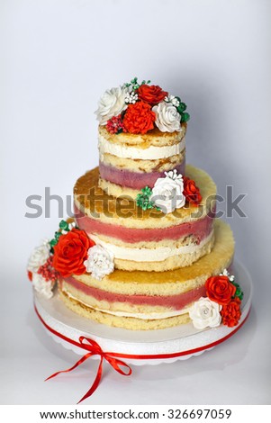 Wedding cake. Naked handmade cake rustic, decorated with roses.