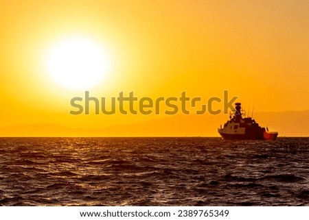 Similar – Image, Stock Photo Sunset sky over wavy sea with floating boats