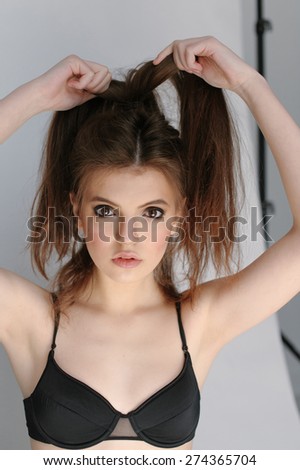 Portrait of a beautiful girl with smoky eyes makeup straightens hair