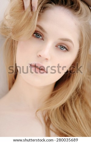 Closeup portrait of a beautiful blonde girl with natural make up