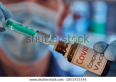 Researcher with face mask fills syringe with vaccine. Covid-19 vaccine. Corona medication. Biontech vaccine. Covid-19 medication. Moderna vaccine. Pfizer Biontech Novavax Curevac Astrazeneca Moderna.