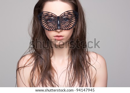 Young woman in fetish mask face hidden