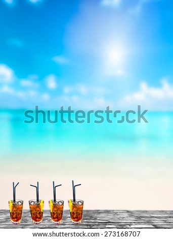 Four cuba libre exotic tasty cocktails background turquoise sea