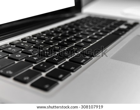 Laptop keyboard on wooden white table