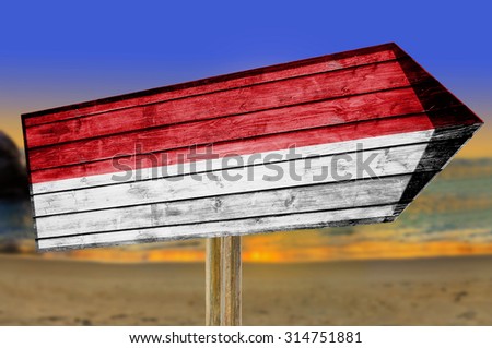 Indonesia Flag wooden sign on beach background
