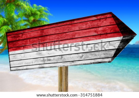 Indonesia Flag wooden sign on beach background