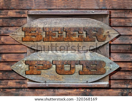 Beer Pub Wooden sign hanged on wooden wall background