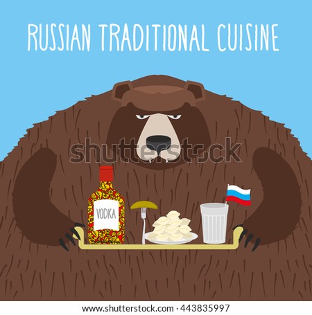  National Folk Food in Russia. Russian national cuisine. Bear with tray of traditional meal: vodka, dumplings and cucumber.