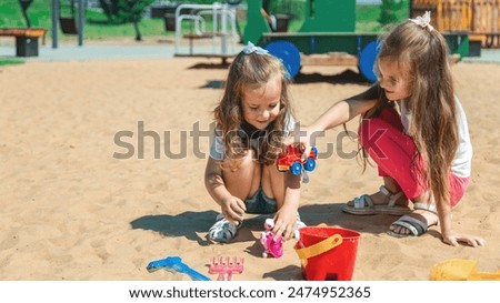 Image, Stock Photo Toddler playing with a colorful plastic bug toy; using hands to manipulate small object developmental milestone