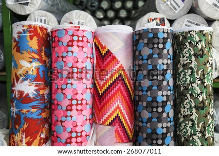 Colorful fabric rolls in warehouse, Focus on front part of rolls