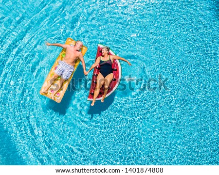 Similar – Image, Stock Photo Mature couple swimming together in fresh water