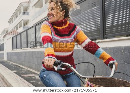 Similar – Image, Stock Photo Middle aged woman riding his electric scooter and looking at mobile phone.