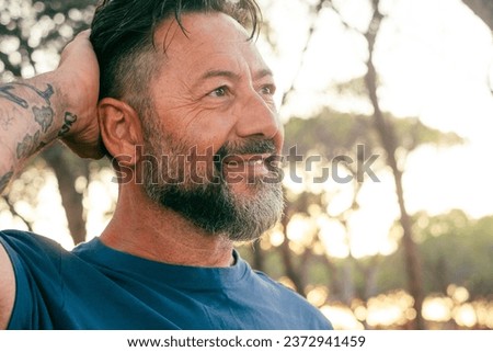 Similar – Image, Stock Photo Close up backlight portrait of a young, freckled woman with wind-blown hair in front of a bush