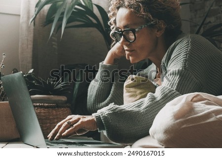 Similar – Serious female surfing laptop near modern building