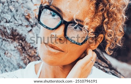 Similar – Image, Stock Photo Focused stylish black woman applying eyeliner at home