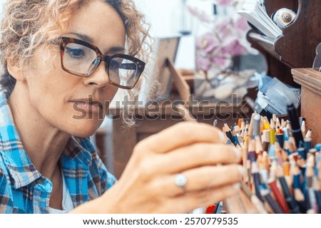 Similar – Image, Stock Photo Focused artist blending paints in palette