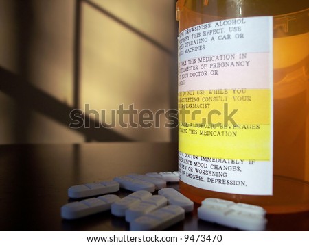 Pills and pill container with a plethora of warning labels.