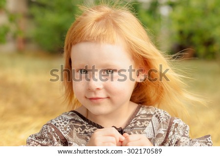 funny red-haired girl with short original bangs cute smiles
