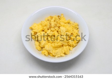 Similar – Image, Stock Photo Scrambled eggs in a blue plate, top view on a yellow table.