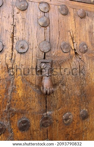 Metal knocker in the shape of a hand on the door of a house in a town in the north of Palencia, Spain Zdjęcia stock © 