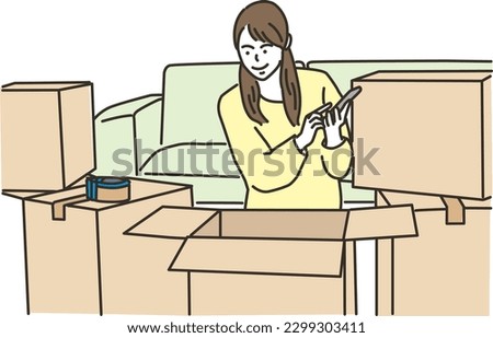 
Young woman with smartphone in front of cardboard