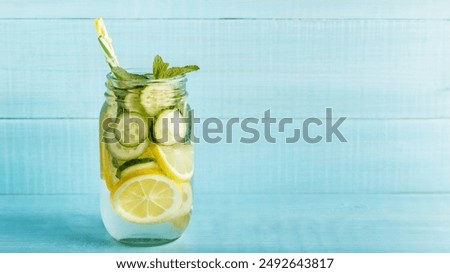 Similar – Image, Stock Photo Tasty infused water in bottle with drinking straw and ingredients: lime, strawberry and mint leaves at white background