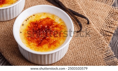 Similar – Image, Stock Photo Creme brulee with caramel crust. Burning sugar on burnt cream