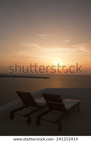 Sun beds in the courtyard at sunset Greece , Santorini