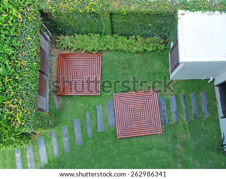 Garden with Stone Walkway and Carved Wooden Objects from Top View
