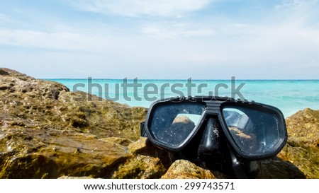 Ready to Dive Concept, Scuba Diving Equipment On The Sea Stone with Crystal Clear Sea and Sky in Background used as Template