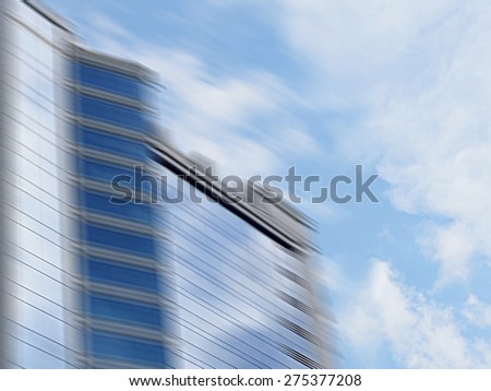 Blurred office building skyscraper on a background of beautiful sky for design calendars, covers and etc. / out of focus